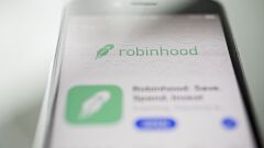 The Robinhood application is displayed in the App Store on an Apple Inc. iPhone in an arranged photograph taken in Washington, D.C., U.S., on Friday, Dec. 14, 2018. The Securities Investor Protection Corp. said a new checking account from Robinhood Financial LLC raises red flags and that the deposited funds may not be eligible for protection. Photographer: Andrew Harrer/Bloomberg