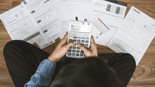 Top view man sitting on the floor stressed and confused by calcu