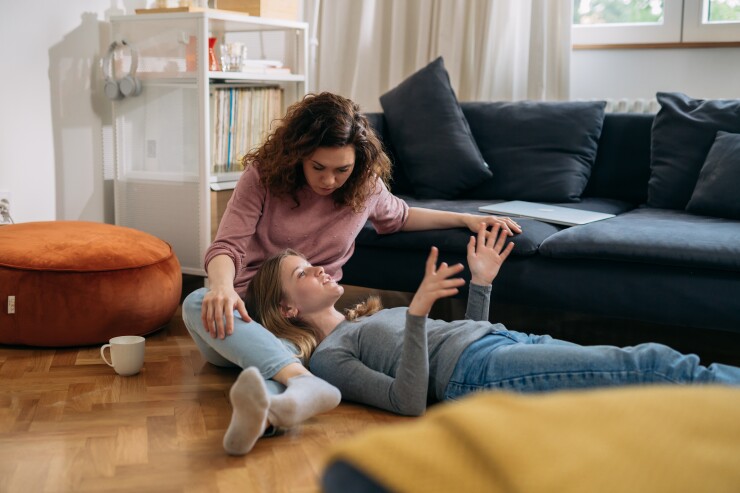 Mom and teen talking to each other in their home.