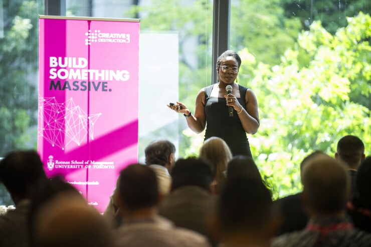 Soton Rosanwo speaks to an audience from a stage