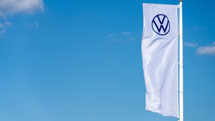 Vilnius, Lithuania - May 16, 2021: The flag of Volkswagen over blue sky. Volkswagen is the biggest German motor vehicle manufacturer