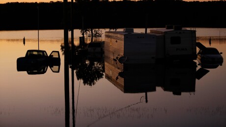 Vehicles and trailers are seen submerged in water at a trailer park flooded by Hurricane Harvey in Rose City, Texas.