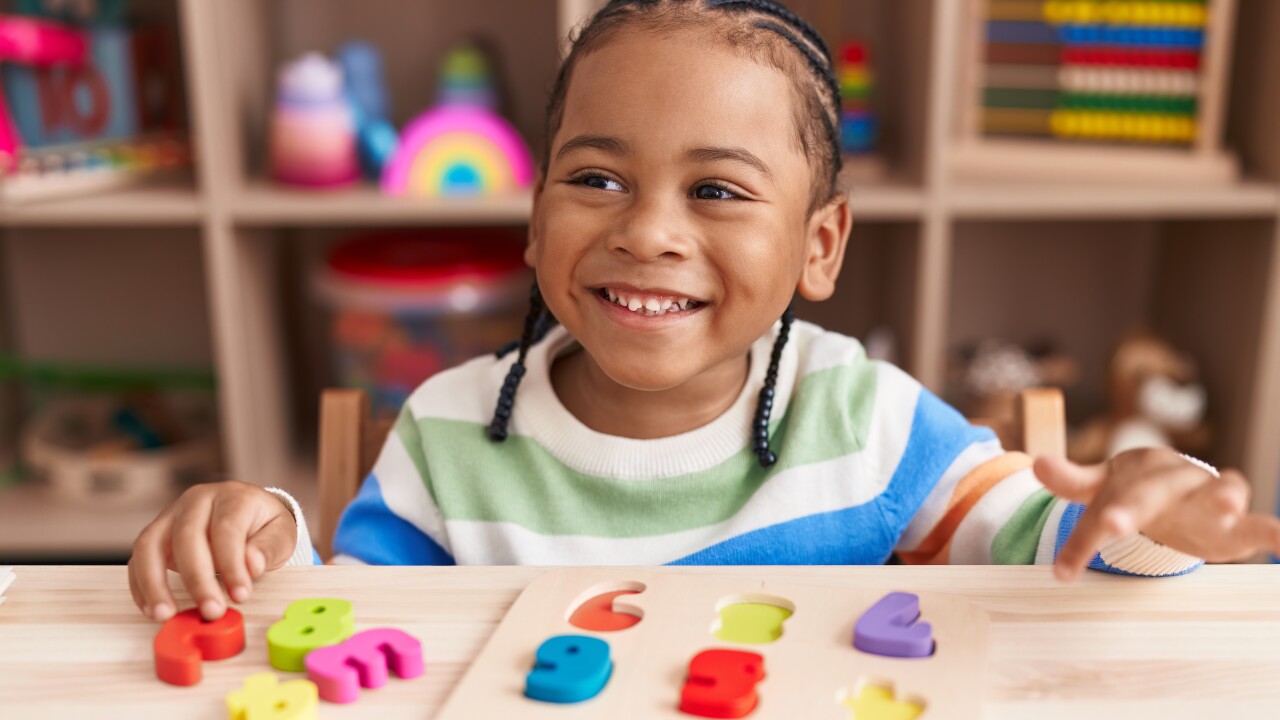 A young boy playing with a math puzzle game.