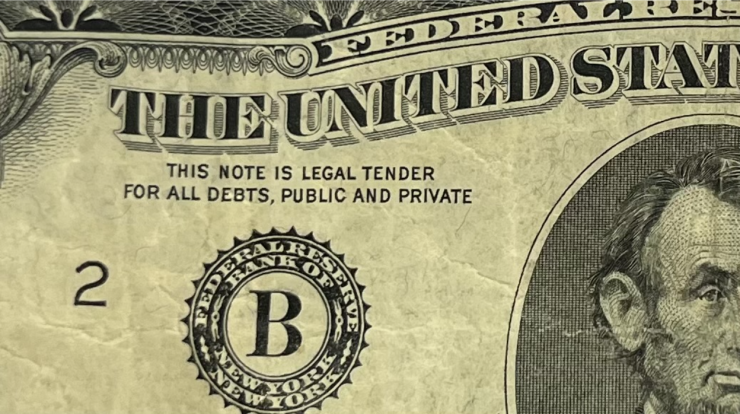 A close-up picture of a $5 bill.
