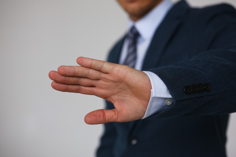 Stock image of a hand gesture that says no, decline reject.