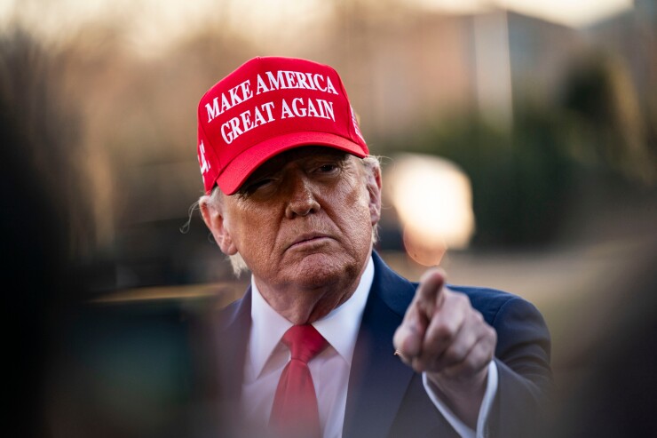 Donald Trump pointing and wearing a Make America Great Again cap
