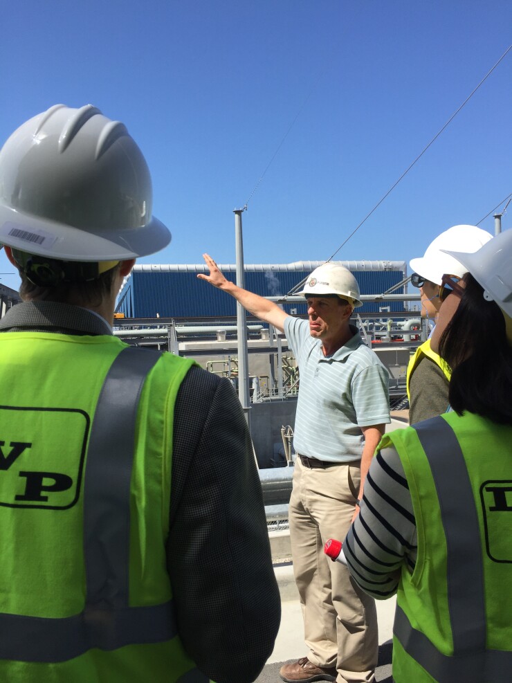 An LADWP employee gives a tour of the Scattergood Power Generating Station during an investor tour in 2016.