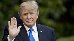 President Donald Trump waves to members of the media before boarding Marine One on the South Lawn of the White House