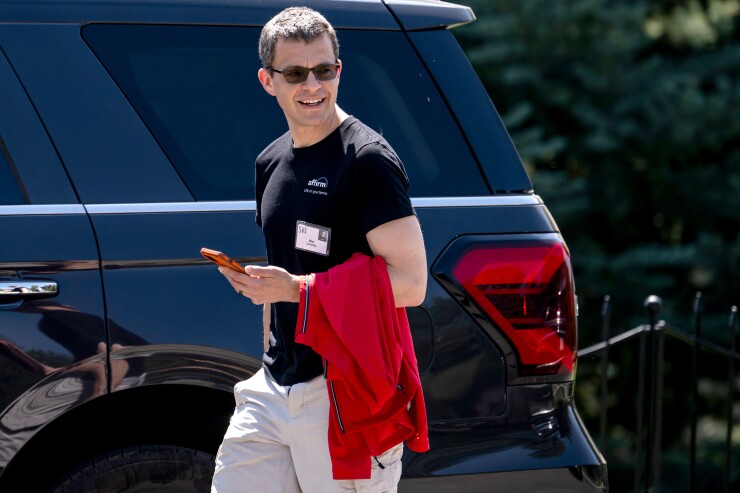 Max Levchin, Affirm CEO, walking past a parked car in a t-shirt.