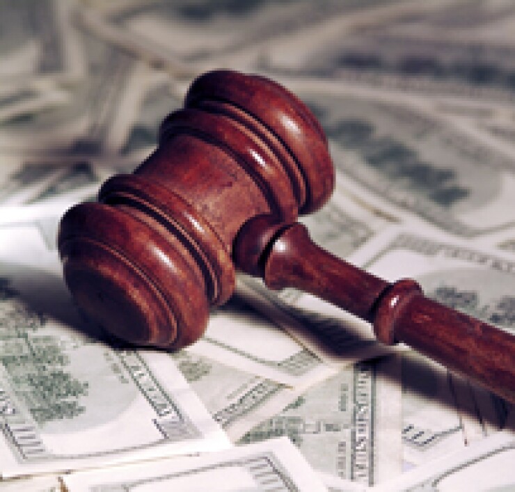 A wooden gavel on top of money