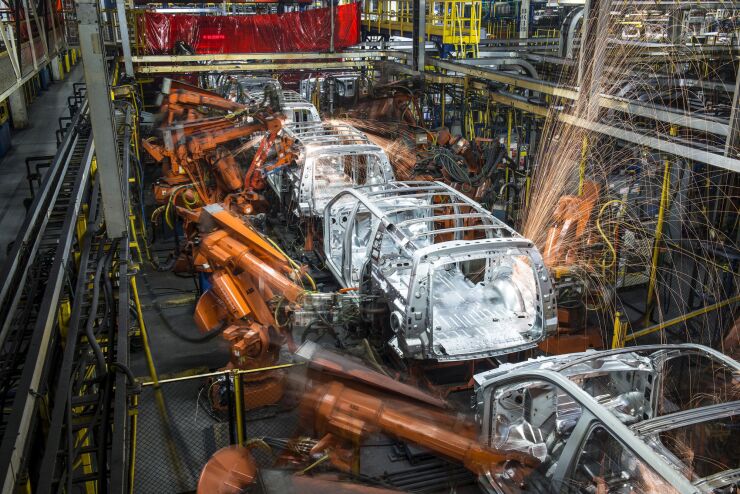 Robotic machines weld together the frames of sports utility vehicles during production at the General Motors assembly plant in Arlington, Texas.
