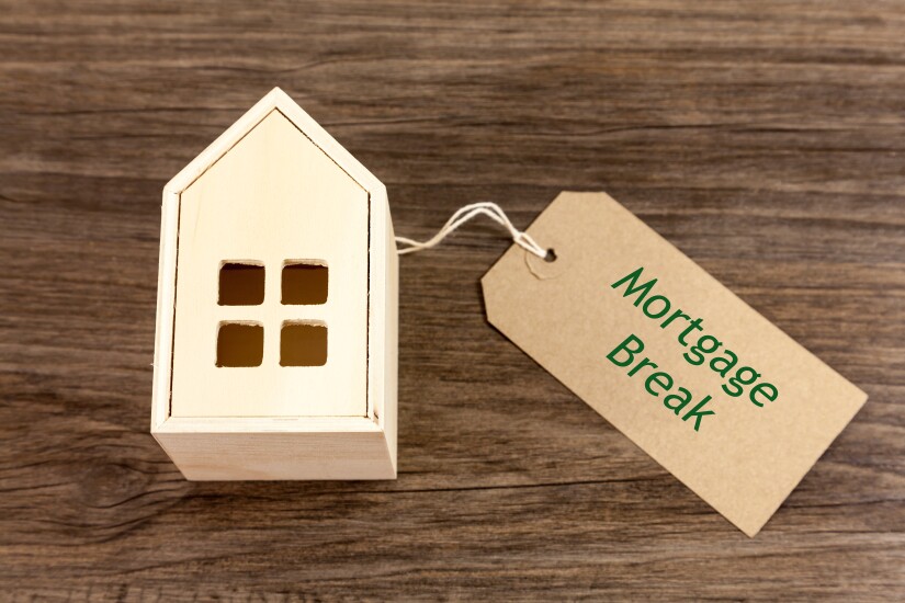 Mortgage Break - Toy wooden house alongside label which reads 'Mortgage Break'