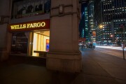 A Wells Fargo bank branch stands at night in New York.