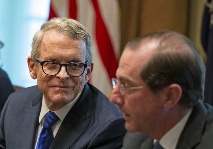 Mike DeWine, governor-elect of Ohio, left, listens during a meeting with U.S. President Donald Trump in the Cabinet Room of the White House in Washington, D.C., U.S., on Thursday, Dec. 13, 2018.