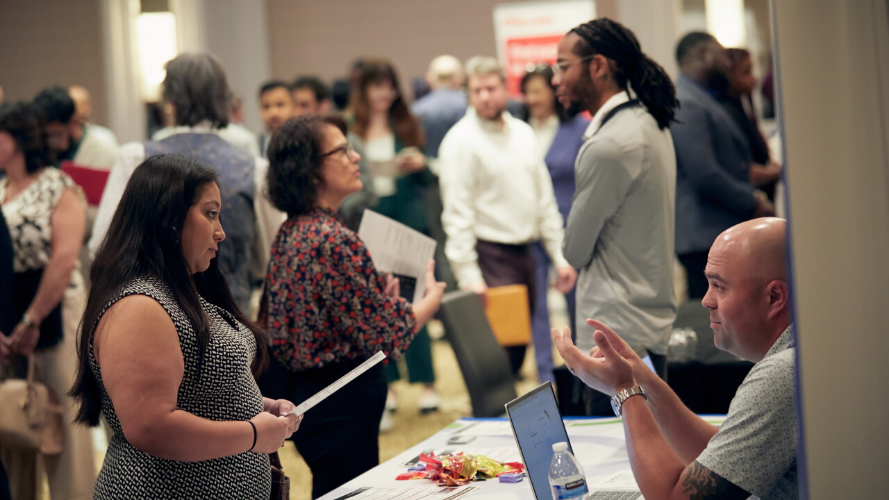A picture of job hunters at a jobs fair.
