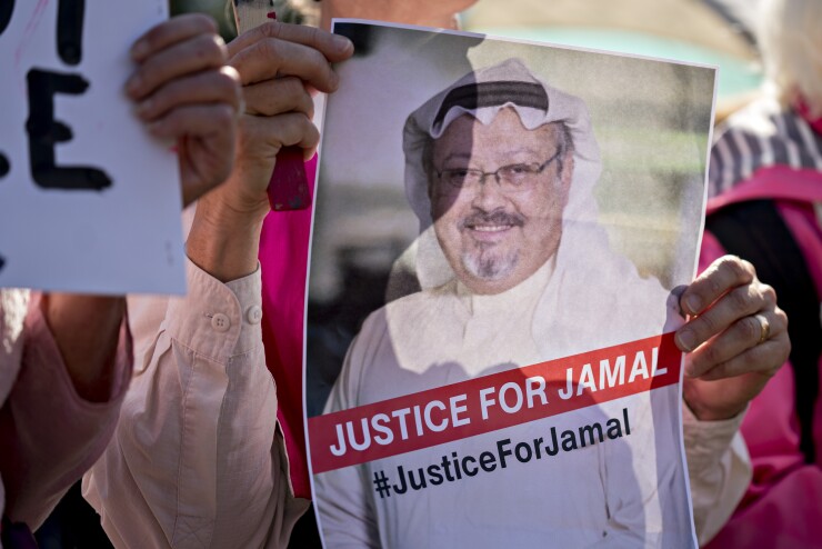 A Codepink demonstrator holds a photograph of journalist Jamal Khashoggi outside the White House in Washington, D.C., U.S., on Friday, Oct. 19, 2018.
