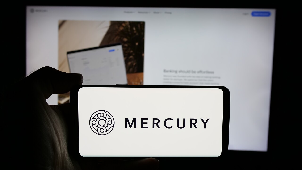 Stuttgart, Germany - 10-31-2024: Person holding cellphone with logo of US fintech company Mercury Technologies Inc. on screen in front of business webpage. Focus on phone display.