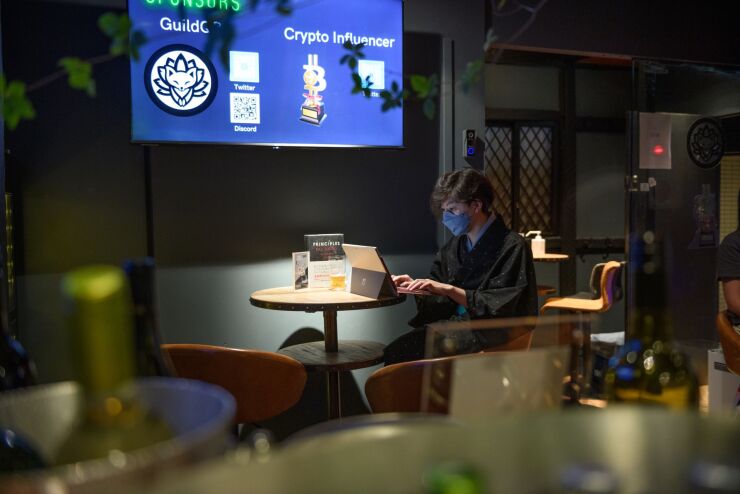 A barkeeper uses a laptop computer inside CryptoBar P2P in the Ginza district of Tokyo, Japan, on Thursday, June 2, 2022. The membership bar for "crypto-tech and crypto-culture enthusiasts" accepts payment in cryptocurrencies only, according to the owner. Photographer: Akio Kon/Bloomberg