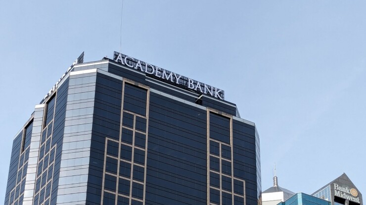 Academy Bank Headquarters signage on top of skyscraper
