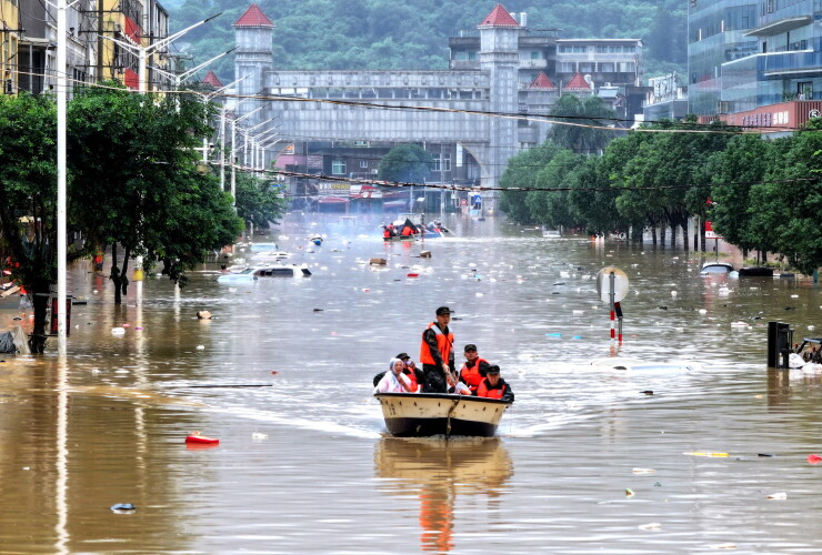 A flooded street with people on a boat