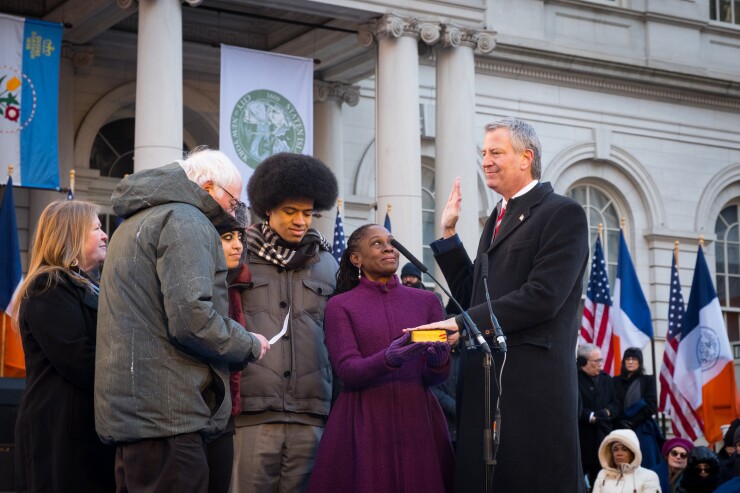 U.S. Sen. Bernie Sanders swears in Bill de Blasio as NYC Mayor on Jan. 1, 2018 with family by his side.