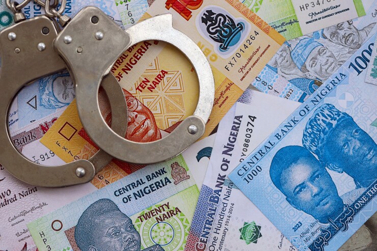 Nigerian naira currency money bills and handcuffs. The concept of criminal