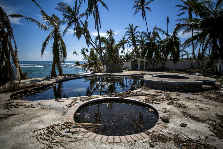 Debris sits near the pool of the damaged Caribe Playa Beach Resort after Hurricane Maria in Patillas, Puerto Rico, on Friday, Oct. 6, 2017. Hurricane Maria devastated Puerto Rico's travel and tourism industry