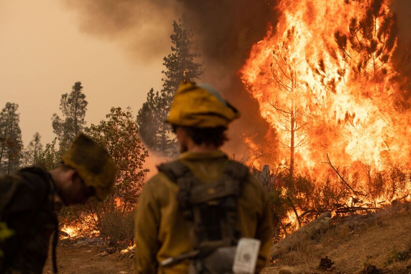 Firefighters watch a backfire operation during the Mosquito fire near Volcanoville, California.