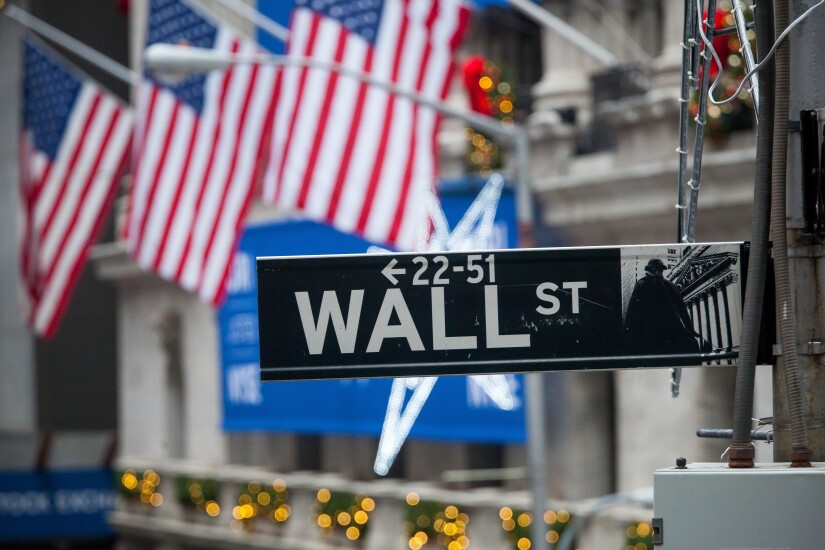 Wall-Street-sign-american-flag-winter-bloomberg