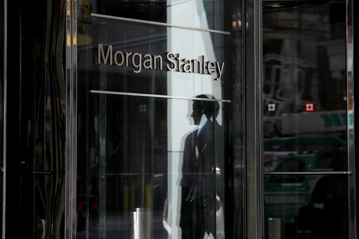 A pedestrian is reflected in the exterior of Morgan Stanley headquarters in New York, U.S., on Thursday, July 12, 2018. Morgan Stanley is scheduled to release earnings figures on July 18. Photographer: Bess Adler/Bloomberg