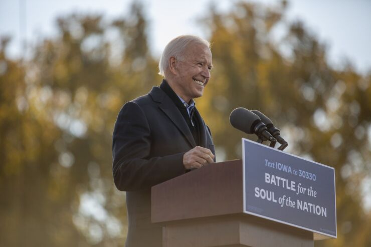 Joe Biden, 2020 Democratic presidential nominee, smiles while speaking during a drive-in rally at the Iowa State Fairgrounds in Des Moines, Iowa, U.S., on Friday, Oct. 30, 2020. Days away from the presidential election, polls give Biden the biggest lead over Donald Trump since Barack Obama trounced John McCain in 2008, yet web searches in the U.S. suggest voters are squarely focused on gauging how Trump may still find a path to victory. Photographer: Rachel Mummey/Bloomberg