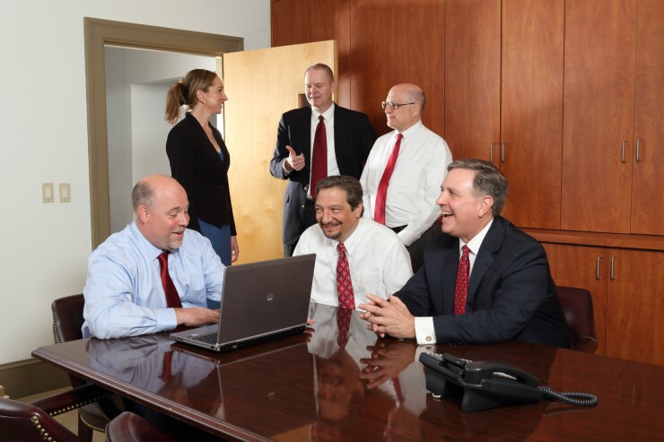 Seated front (left to right): William Gowie (founding partner), Louis Schiazza (partner) and Peter Barsz (partner). Standing (left to right): Marissa Sperazza, Richard Brennan (partner) and Michael Amon (partner)