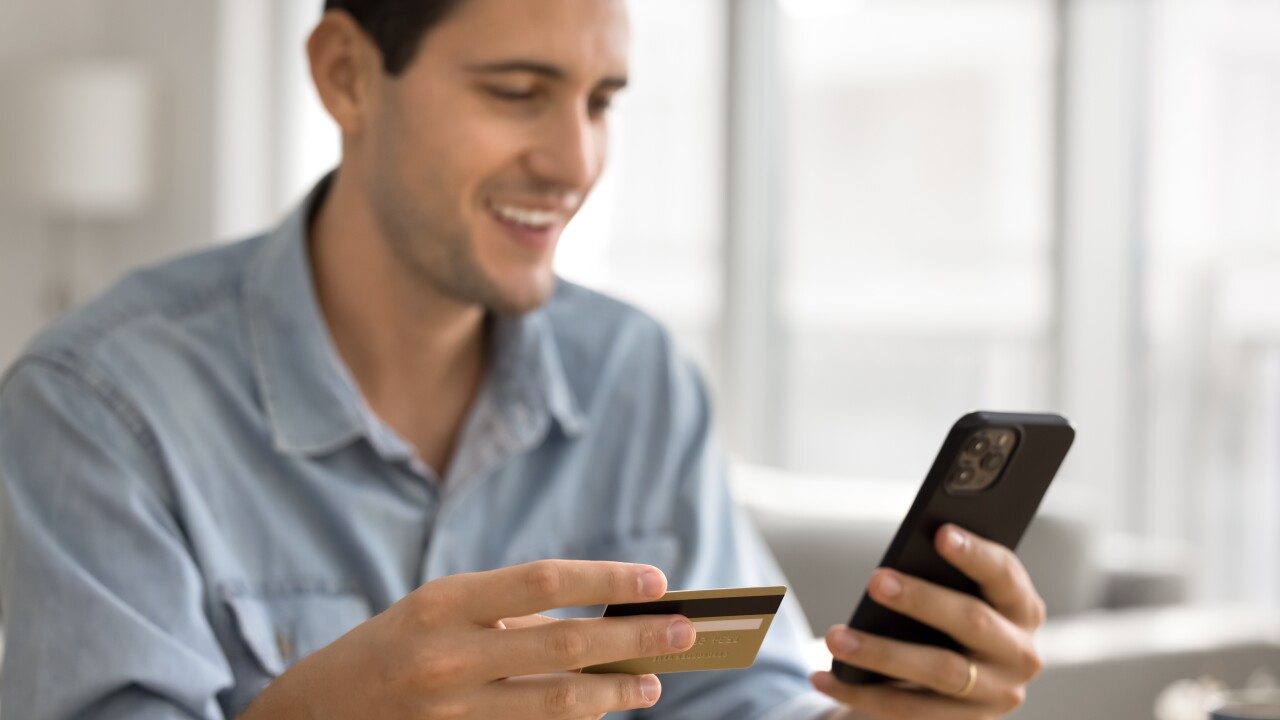 Man using credit card to pay by phone
