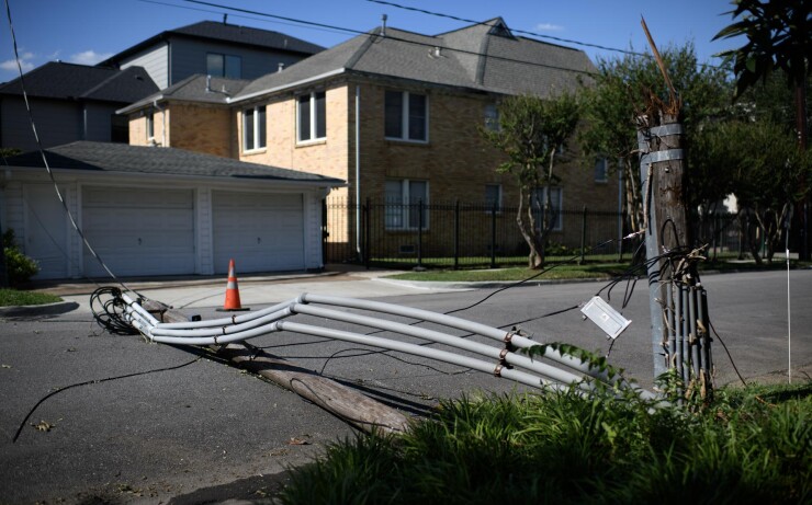 Broken utility pole in Houston street after Hurricane Beryl