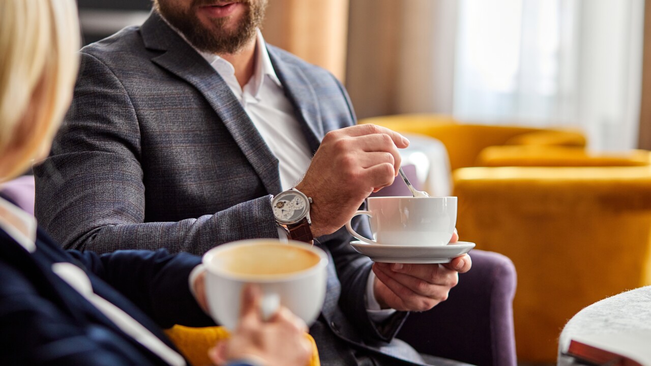 Two colleagues have coffee together.