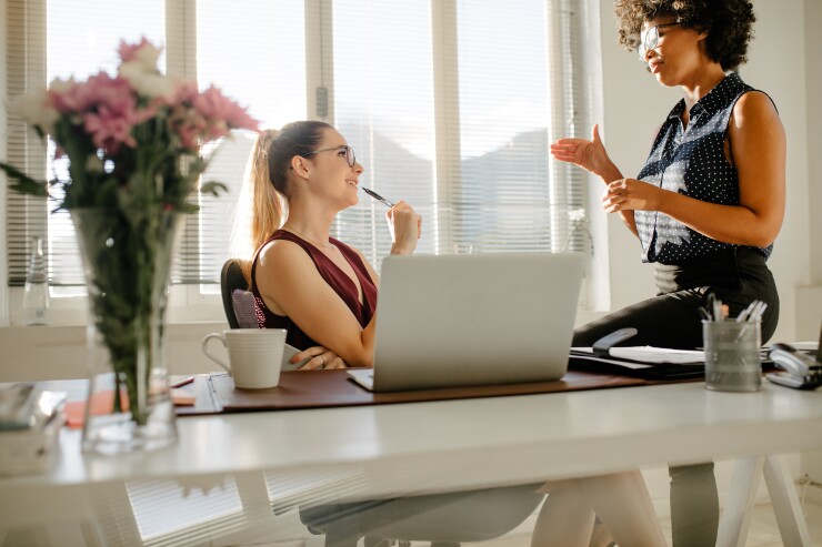 Two female employees talking