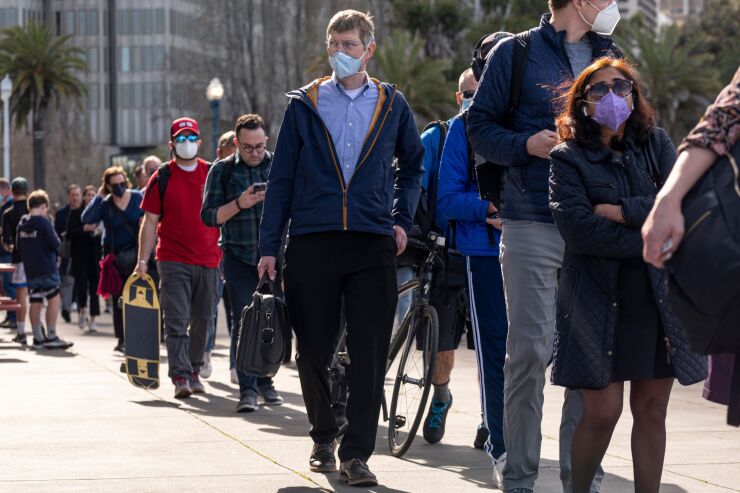 Commuters wait to board a San Francisco Bay ferry in San Francisco, California, U.S., on Monday, March 14, 2022. San Francisco Mayor London Breed is planning a week of special programs to entice workers to return to downtown offices, ranging from fitness classes to stand-up comedy. Photographer: David Paul Morris/Bloomberg