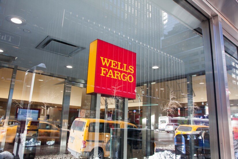 Signage is displayed at a Wells Fargo bank branch in New York.