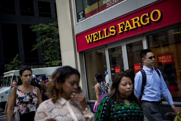 Wells Fargo people walking by Bloomberg News