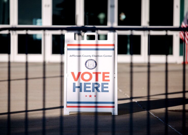 A "Vote Here" sign outside a polling location for the 2020 Presidential election in Louisville, Kentucky, U.S., on Tuesday, Nov. 3, 2020. American voters, at least those who've not yet cast ballots, go to the polls Tuesday to choose between President Donald Trump and Democratic nominee Joe Biden and cast votes in U.S. House and Senate races and state and local elections. Photographer: Scotty Perry/Bloomberg