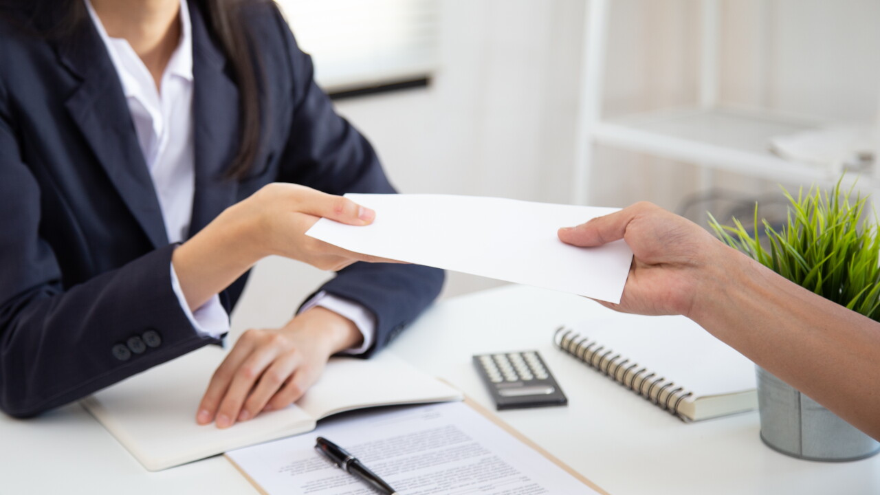 Close up view of Young Asian business woman receiving salary or bonus money from boss or manager at office happily.