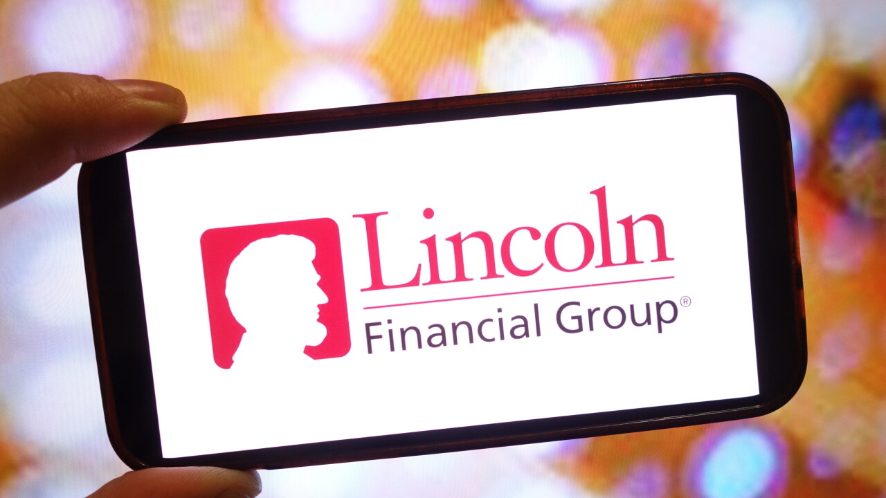 A person holding a phone with the Lincoln Financial Group logo on the screen.
