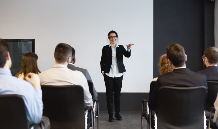 Woman speaking to a group of professionals