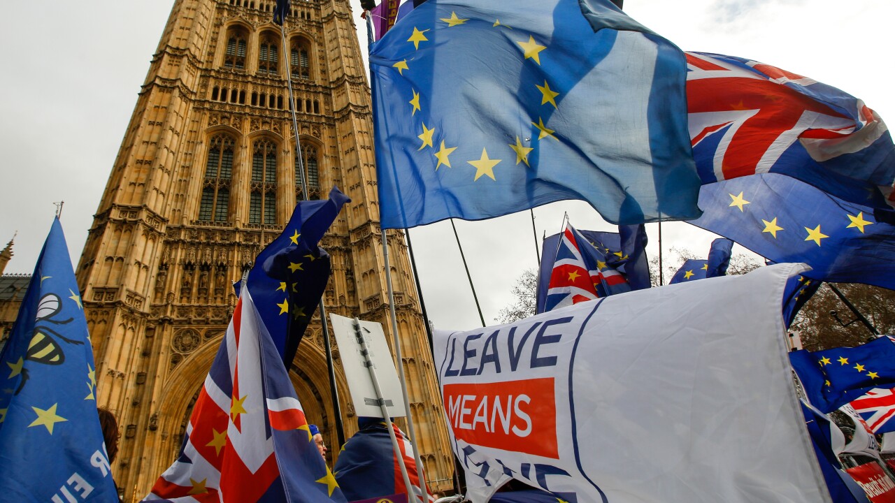 Anti and pro-Brexit demonstrators wave European Union (EU), British Union flags, also known as Union Jacks, and banners during protests outside the Houses of Parliament in London.