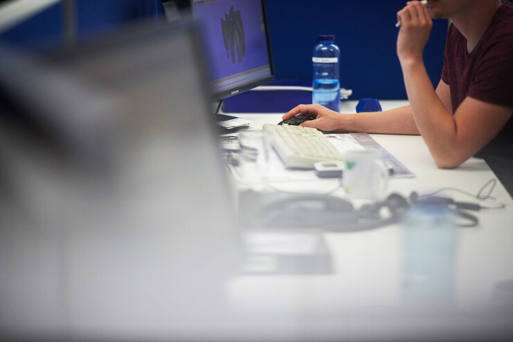 An employee works at a desktop computer in the product development department at the EBM-Papst GmbH ventilation system factory in Mulfingen, Germany,