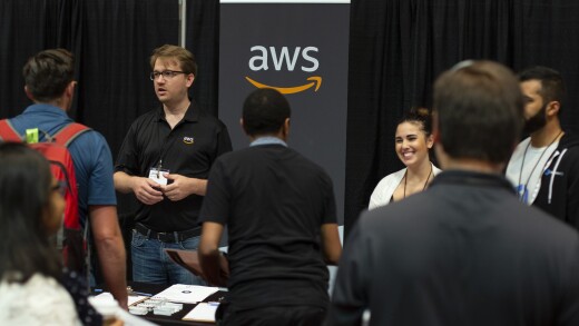 Amazon Web Services logo and people around it