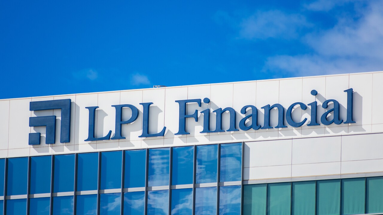 The top of an office building with the logo of LPL Financial against a blue sky