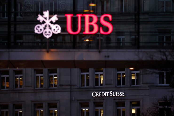 A Credit Suisse Group bank branch beyond a UBS Group office building in Zurich, Switzerland in 2023.