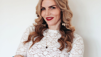 A woman smiles for a potrait.