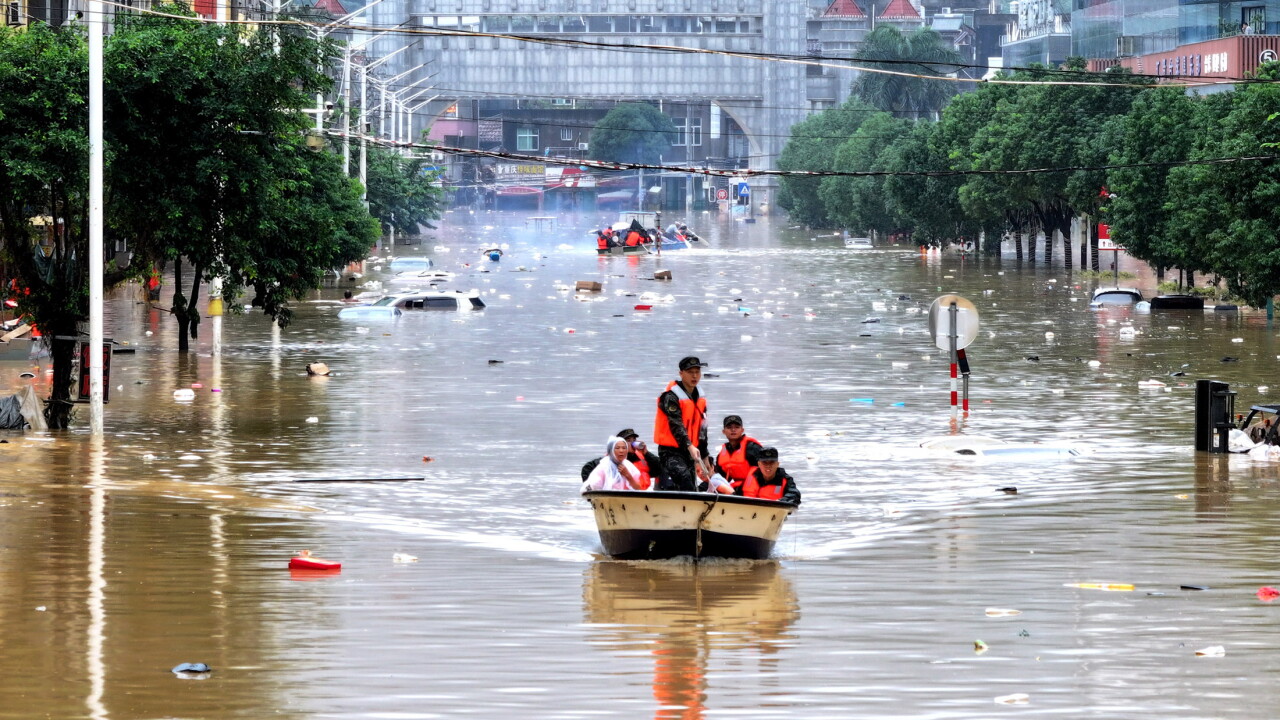 A flooded street with people on a boat